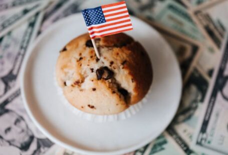 International Foods - Tasty cake with flag on bunch of paper dollars