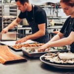 Chefs - Man and Woman Wearing Black and White Striped Aprons Cooking