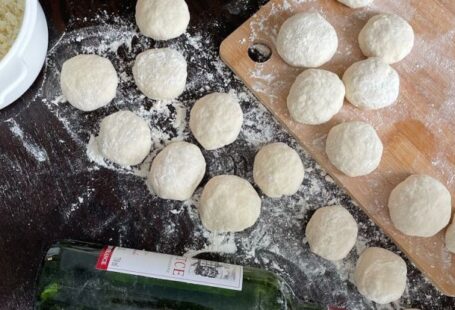 Slow Cooking - A table with dough, flour and a bottle of wine
