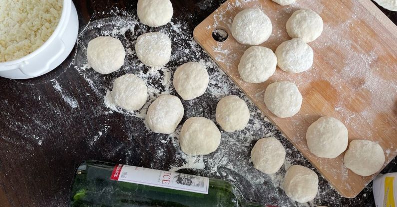 Slow Cooking - A table with dough, flour and a bottle of wine
