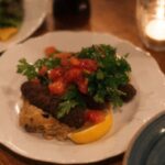 Iconic Dishes - A table with plates of food and drinks