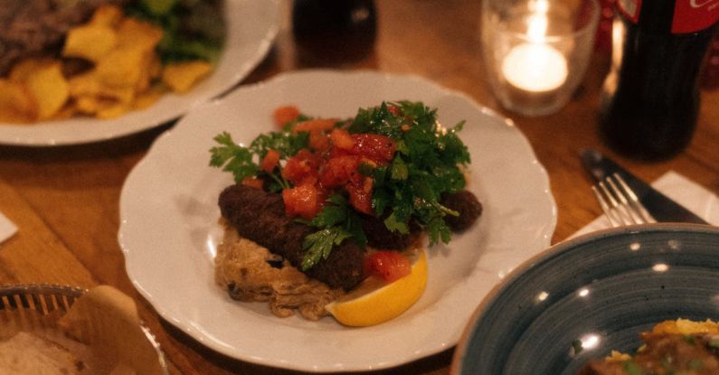 Iconic Dishes - A table with plates of food and drinks