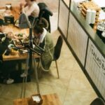 Festival Street Eats - People Eating in Front of Food Stalls
