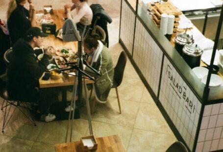 Festival Street Eats - People Eating in Front of Food Stalls