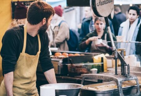 Food Festival - Man Standing in Front of Bowl and Looking Towards Left