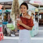Street Vendors - A Woman Smiling and Holding a Smoothie Drink