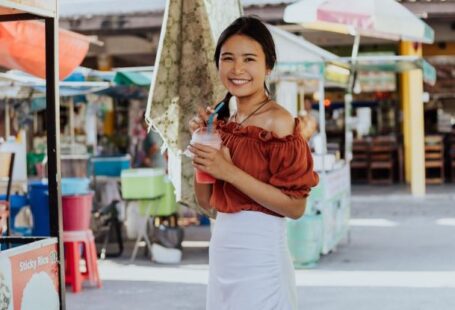 Street Vendors - A Woman Smiling and Holding a Smoothie Drink
