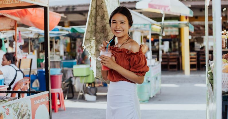 Street Vendors - A Woman Smiling and Holding a Smoothie Drink
