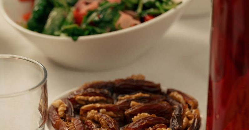 Food Culture - A table with plates of food and a glass of wine