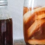 Fermentation - Jars with kombucha and dark herbal beverage