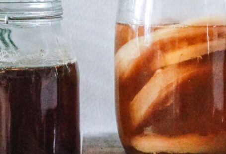 Fermentation - Jars with kombucha and dark herbal beverage