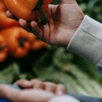 Vegan Options - Anonymous buyer with bell pepper in supermarket