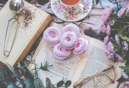 Coffee Ceremonies - Floral Ceramic Cup and Saucer Above Open Book